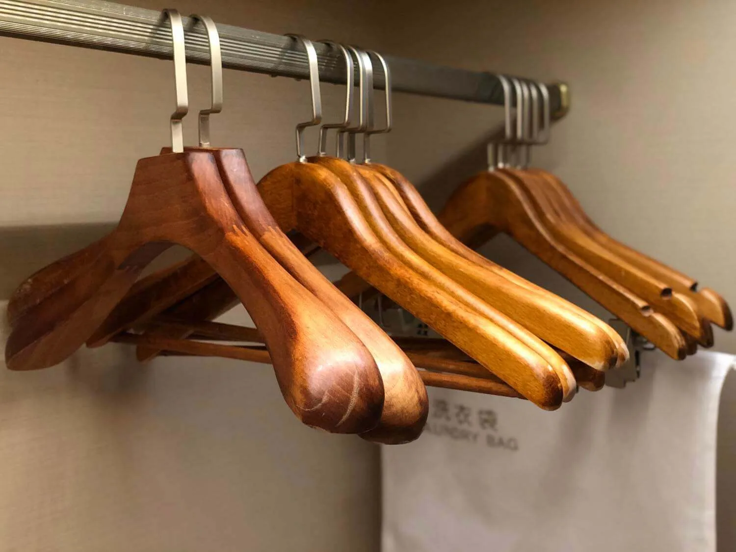 Logo wooden hangers and laundry bags in Hilton hotel room wardrobes